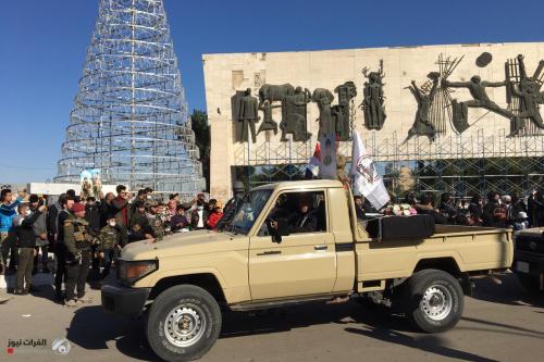 بالصور .. الحشد الشعبي ينظم مسيرة منددة بإغتيال المهندس وسليماني وسط بغداد